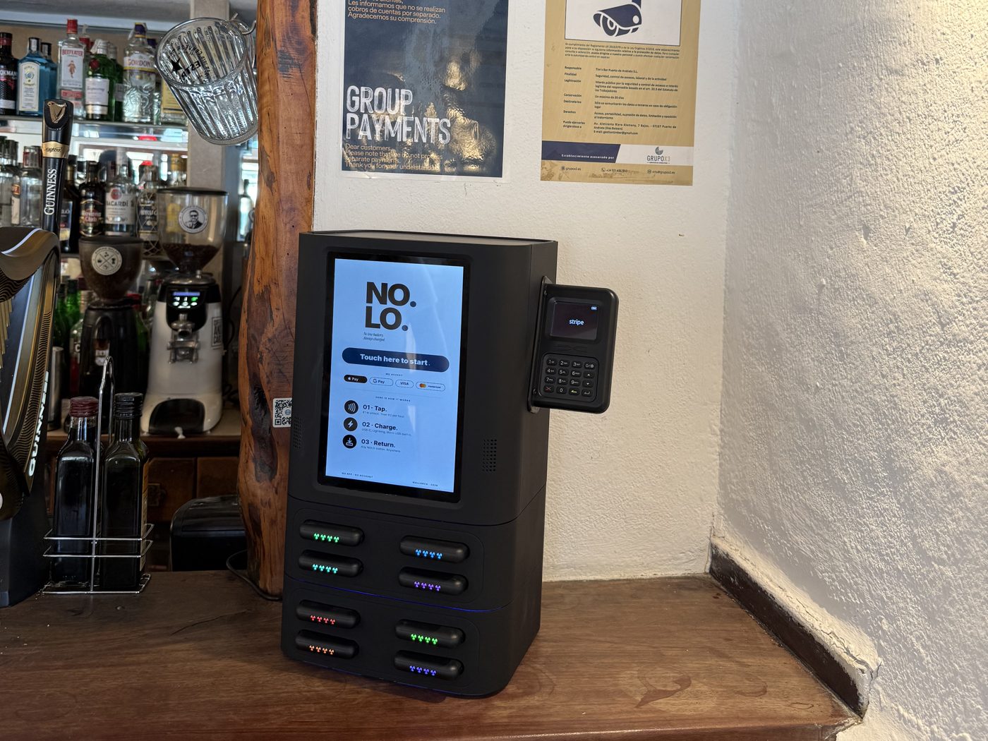 NOLO station live at Tim's — eight slots, Stripe reader, touch screen